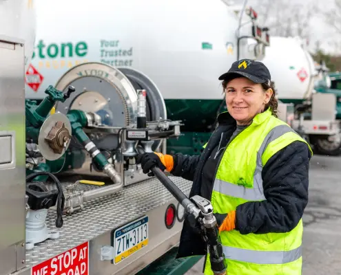 Keystone Propane employee pulling hose from propane truck