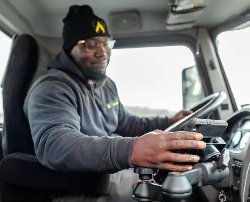 Employee using tablet in delivery truck