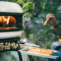 chef using gozney dome pizza oven to cook salmon
