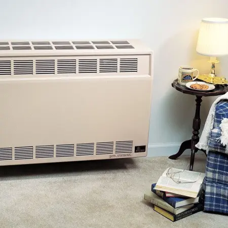 Empire heater installed in wall near chair