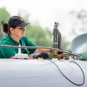 Employee filling large propane tank