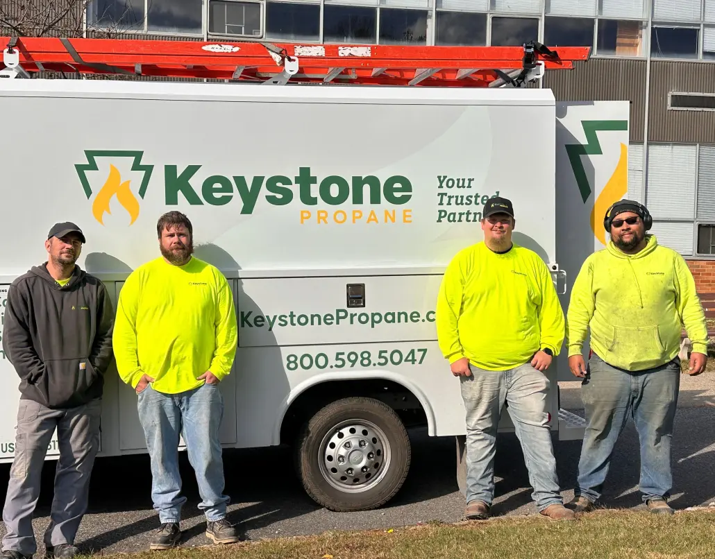 Employees standing in front of service van