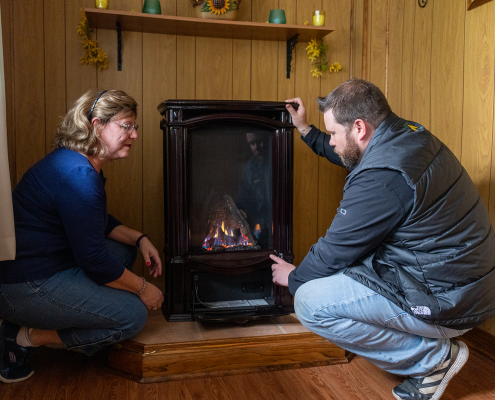 Keystone technician walking a customer through the use of their propane stove.