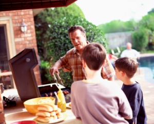 Father and sons barbecuing
