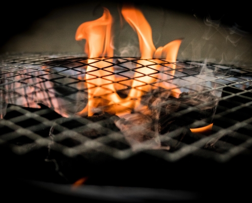 flames coming up inside a grill winter grilling