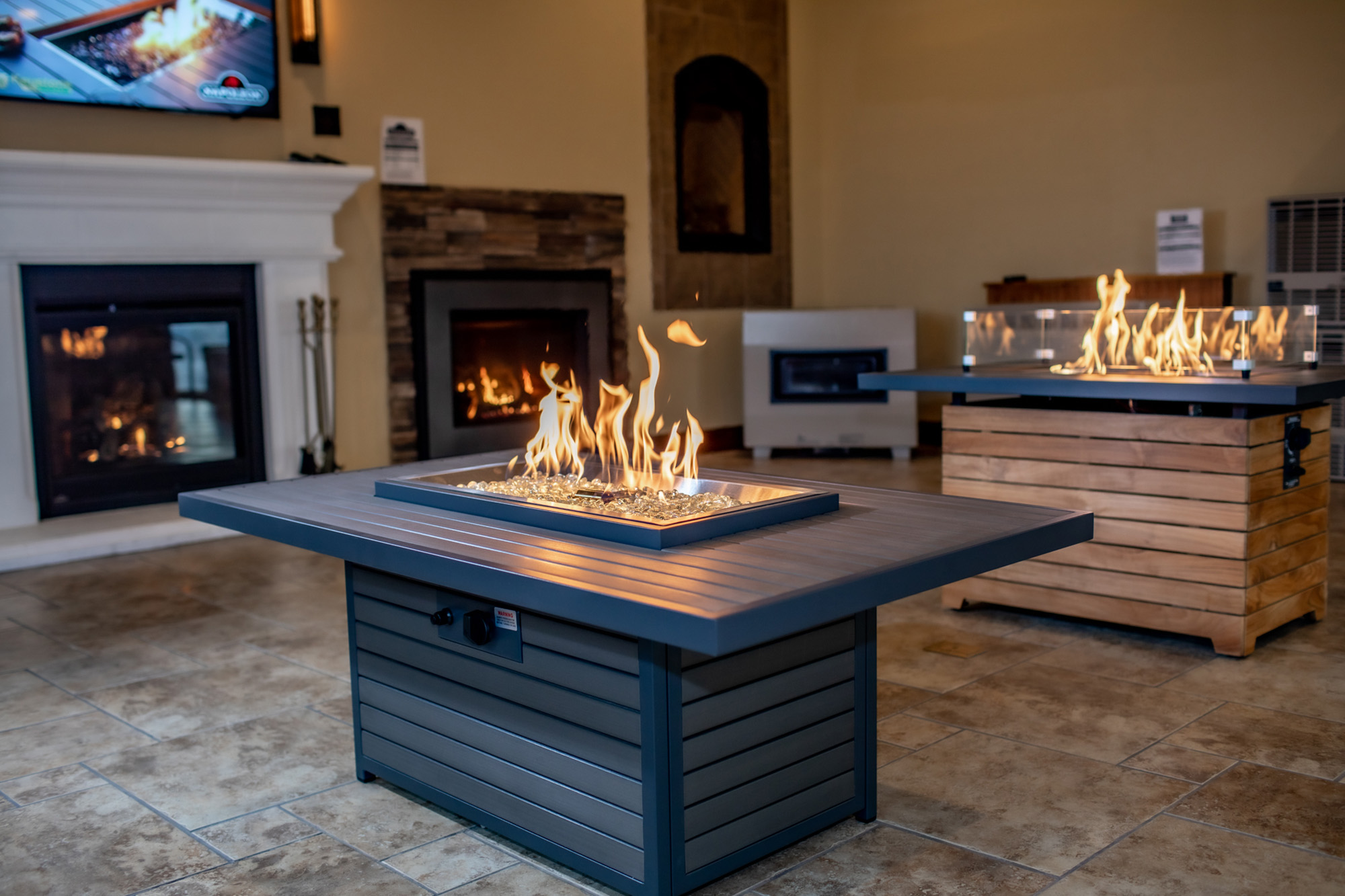 Fire pit tables lit in Throop showroom