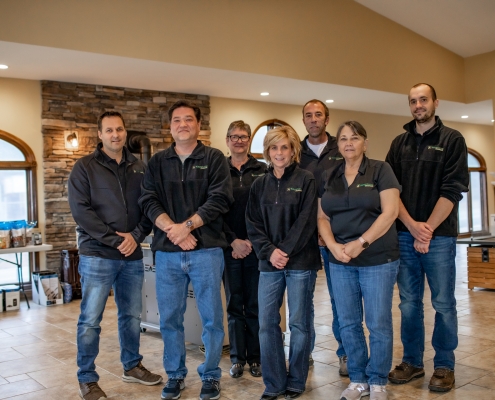 Group shot of office employees standing in showroom