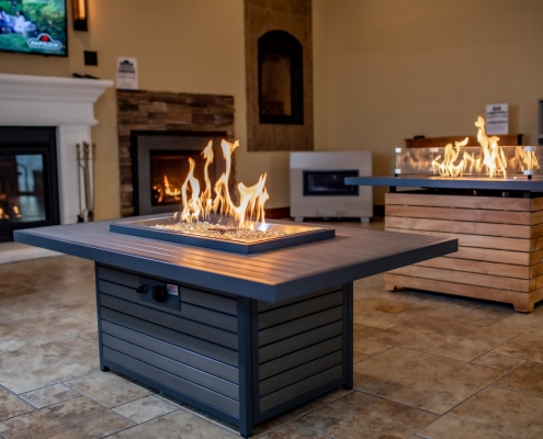 Closeup of fire pit tables lit in showroom