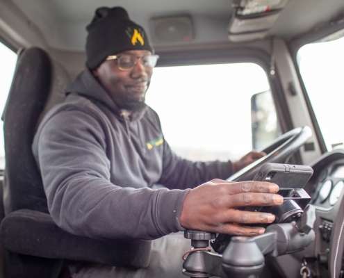 Employee inside truck operating tablet