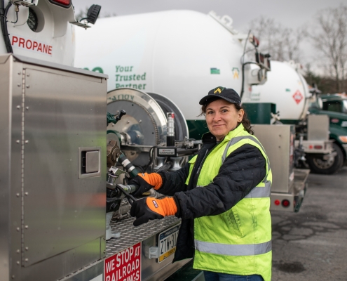 Employee at rear of truck looking at camera