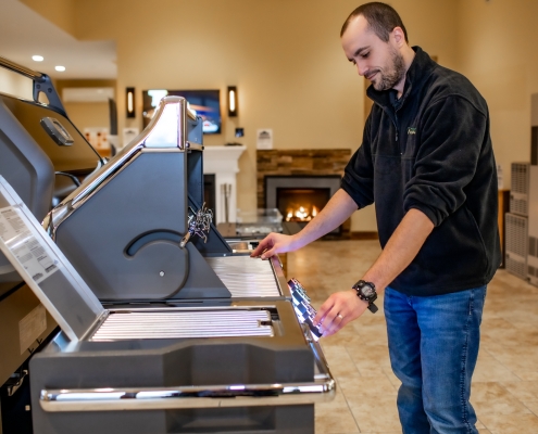 Employee demonstrating Broilmaster grill