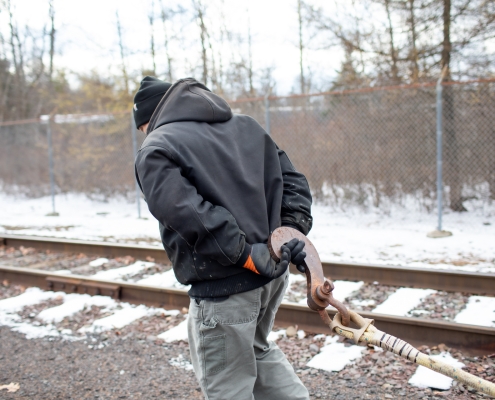 Employee holding tow rope for railcar