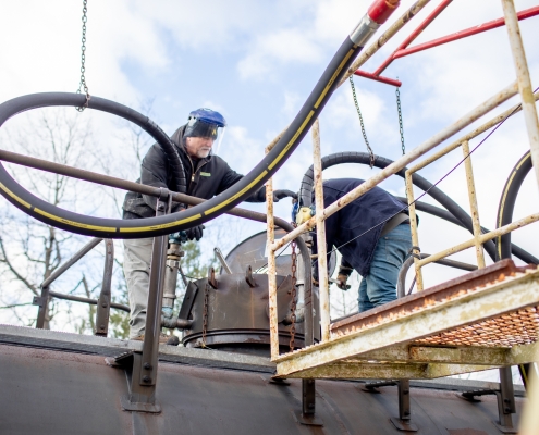 Employees on top of railcars