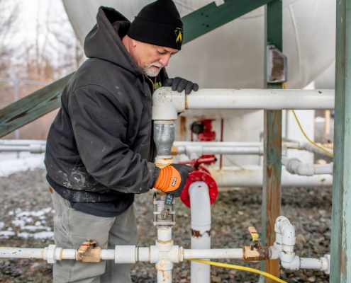 Employee working on piping