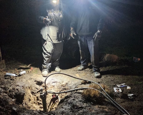 Two employees with headlamps working at night