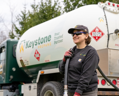 Employee dragging hose away from truck