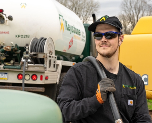 Employee pulling hose from truck