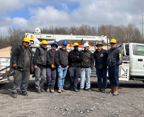 Employee group shot in front of crane