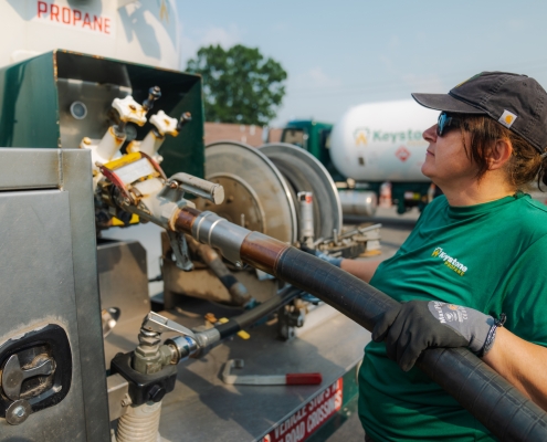 Employee attaching hose to bobtail