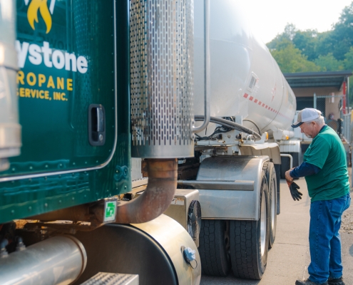 Employee putting on gloves next to transport