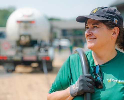 Employee with delivery hose smiling