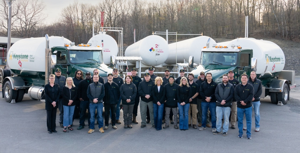 Group shot standing in front of Keystone Propane trucks