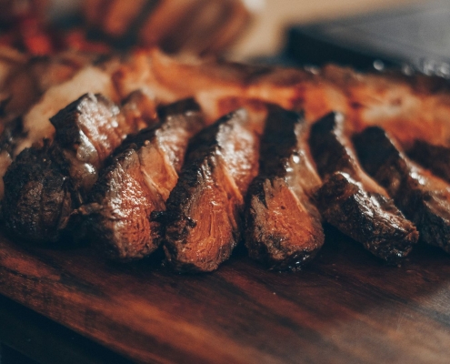 Cut steak fanned out on cutting board