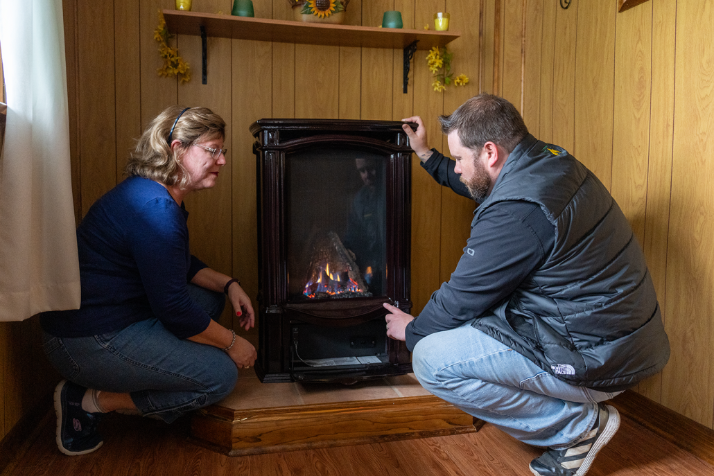 Keystone technician walking a customer through the use of their propane stove.